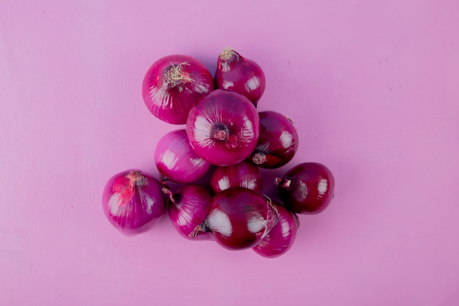 top view red onions purple background with copy space 1