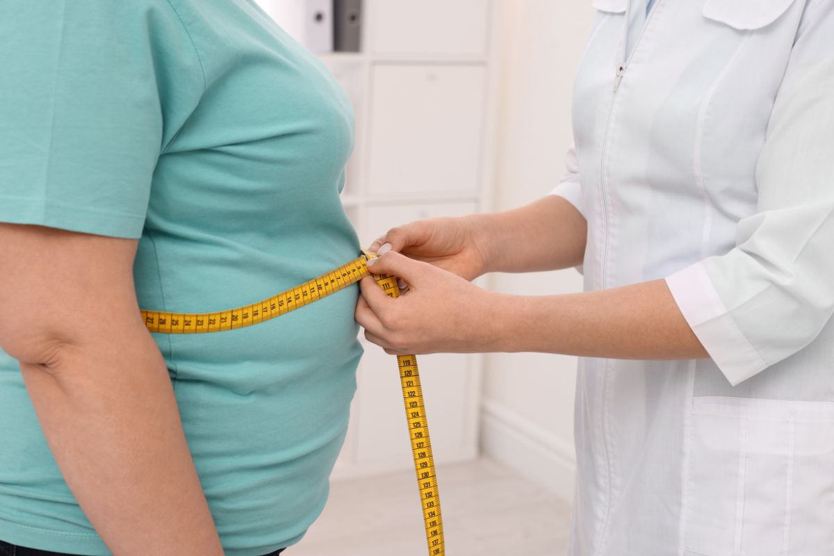 Por que dietas falham? Estudo liga obesidade em mulheres à falta de um mineral essencial 1 mulher obesa sendo medida por uma profissional de saúde.