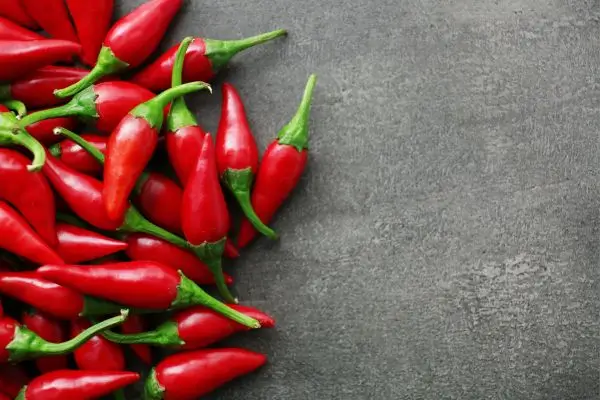 Pimenta faz mal para o fígado? Entenda seus efeitos reais na saúde hepática 2 Pimenta malagueta inteira sobre a mesa.